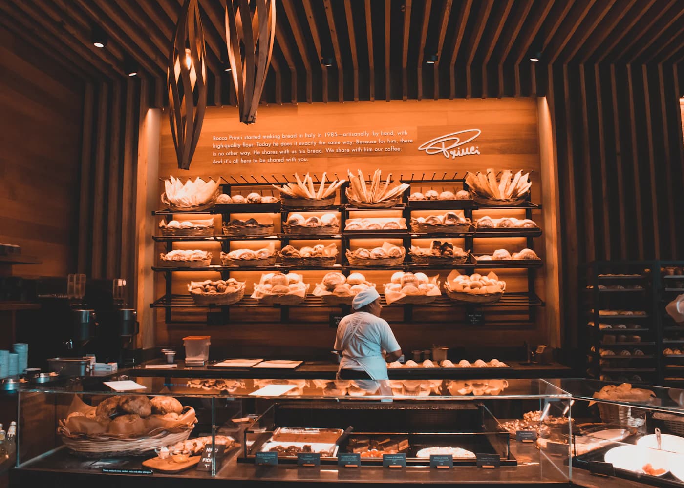 Baker shaping dough during the early bake