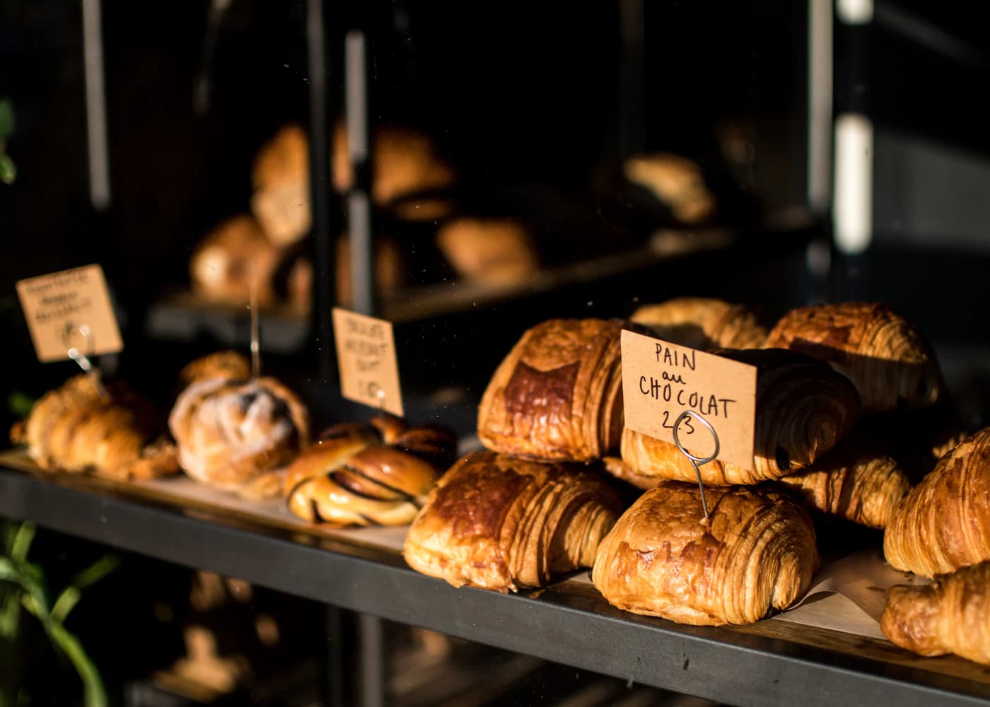 Fresh croissants arranged in the bakery display
