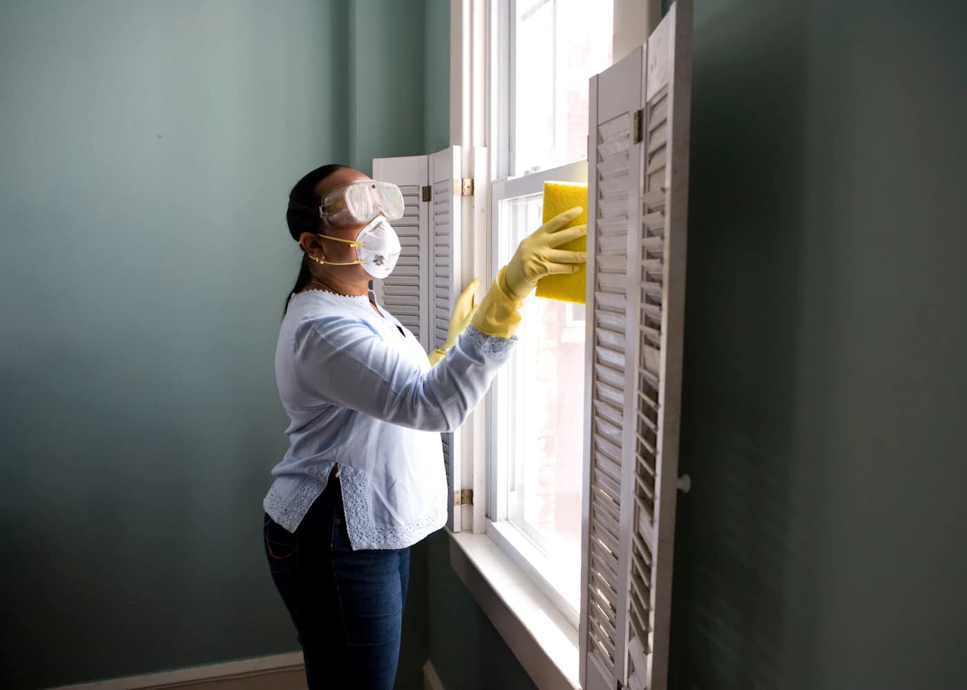 A professional cleaner working in a bright modern home
