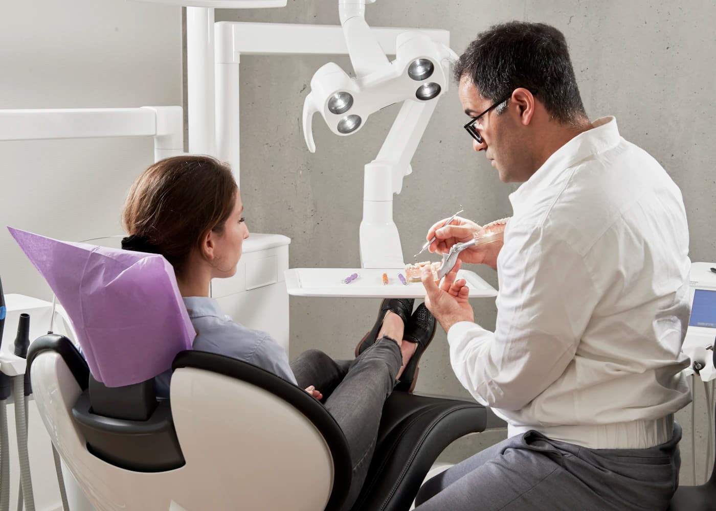 The same patient reviewing the planned dental result with her dentist